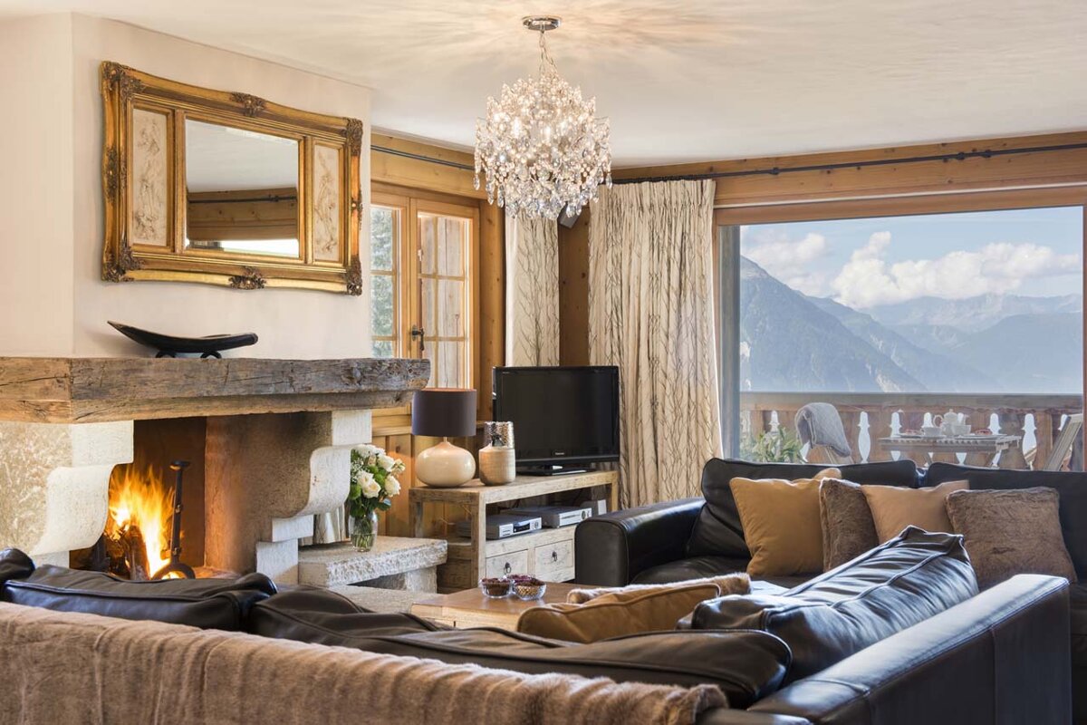 A living room with a fireplace and a flat screen tv