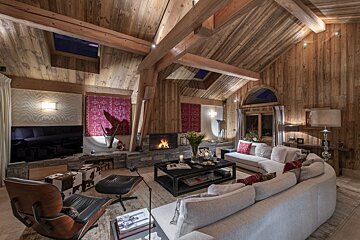A living room with a couch a chair and a fireplace