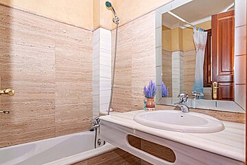 A bathroom with a sink a bathtub and a mirror