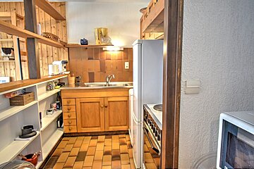 A kitchen with a box on the shelf that says chocolate