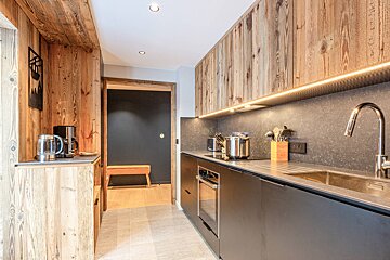 A kitchen with wooden cabinets and stainless steel appliances