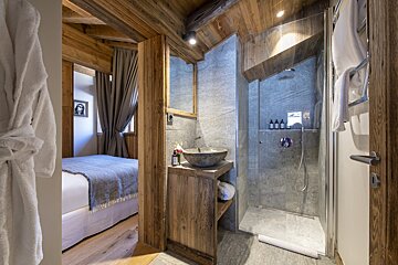 A bathroom with a sink and a walk in shower