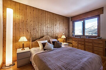 A bedroom with a bed and a sign that says love