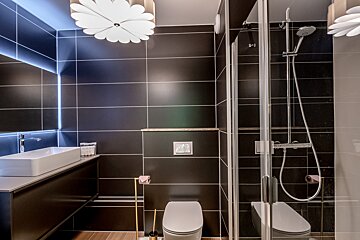 A bathroom with a toilet a sink and a shower