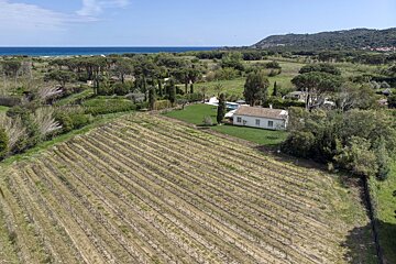 An aerial view of a house in the middle of a field