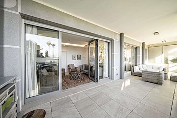 A sliding glass door opens to a living room