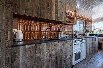 A kitchen with wooden cabinets and a white stove