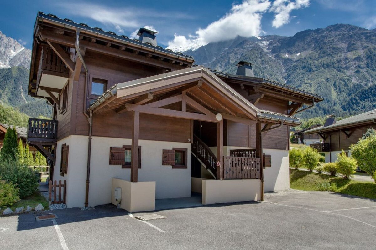 A wooden house with mountains in the background