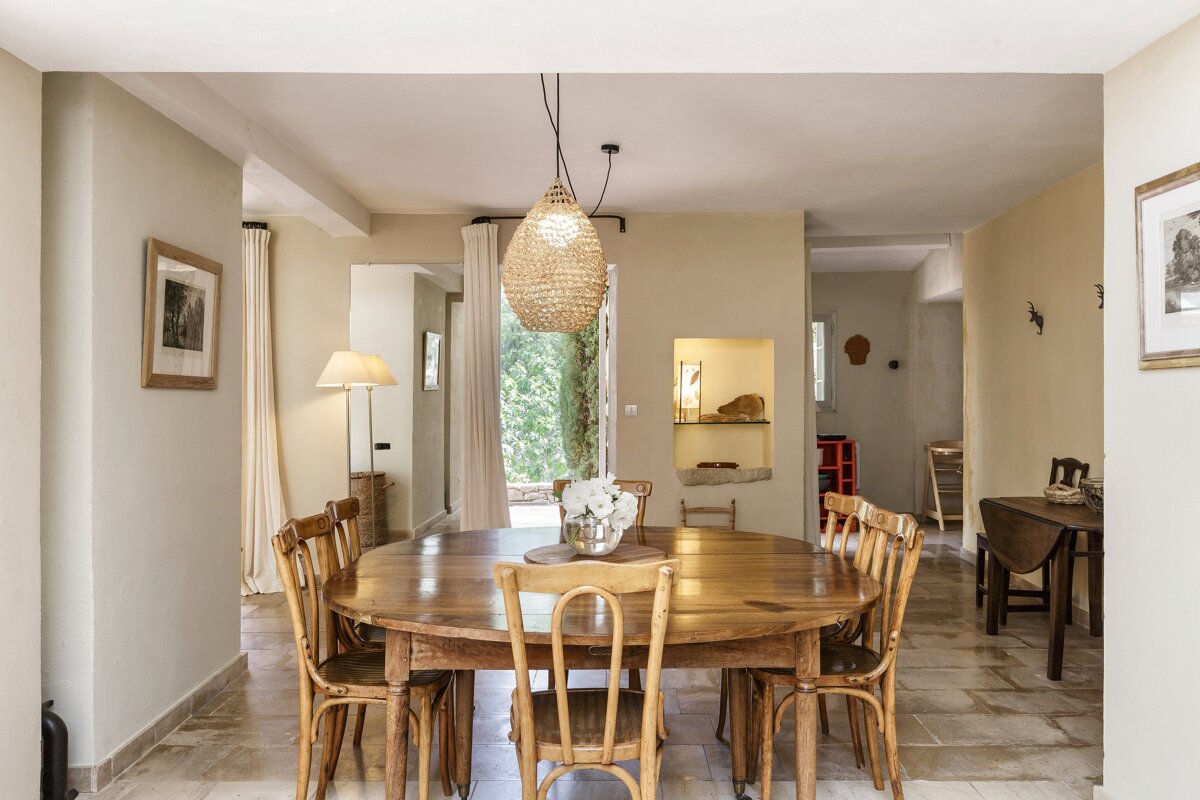 A dining room with a wooden table and chairs
