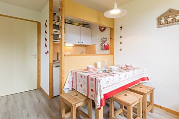 A kitchen with a table and stools and a sign that says home