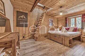 A bedroom with a bed and a sign that says mont blanc