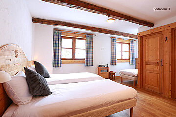 A bedroom with two beds and a sign that says bedroom 3