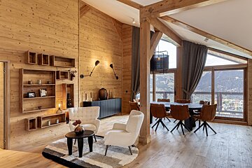 A living room with a dining room table and chairs