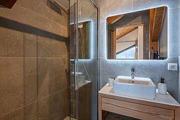 A bathroom with a sink and a large mirror