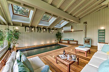 A living room with a swimming pool in the middle
