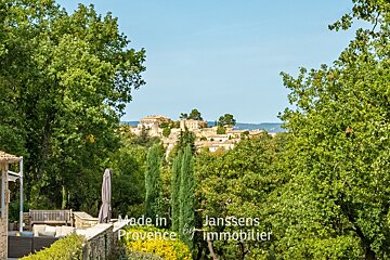 A view of a village with the words made in provence by immobilier