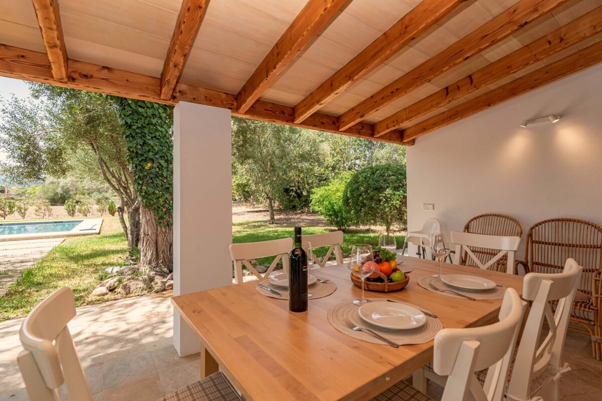 A table with plates and a bottle of wine on it