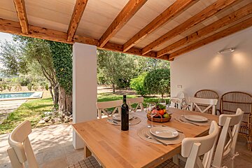 A table with plates and a bottle of wine on it