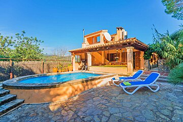 A house with a swimming pool in front of it