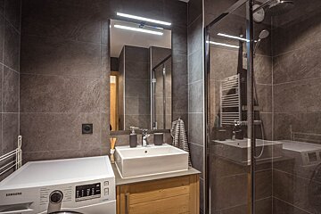 A bathroom with a samsung washer and dryer