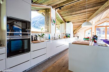 A kitchen with white cabinets and a siemens oven