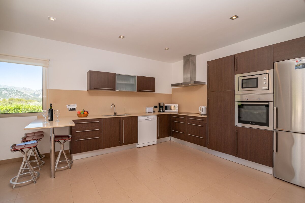 A kitchen with stainless steel appliances and wooden cabinets