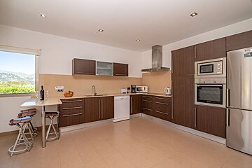 A kitchen with stainless steel appliances and wooden cabinets