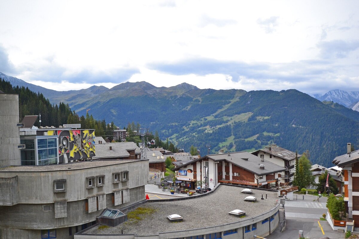 A building with a mural on the side of it that says ' switzerland ' on it