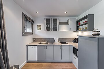 A small kitchen with a sign on the wall that says