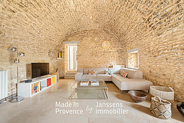 A living room with a couch and a tv made in provence by janssens immobilier