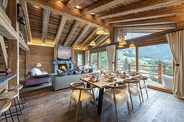 A living room with a table and chairs and a fireplace