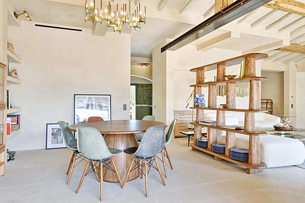 A dining room with a round table and chairs