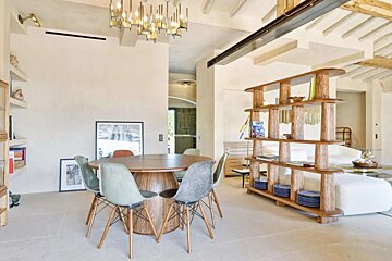 A dining room with a round table and chairs