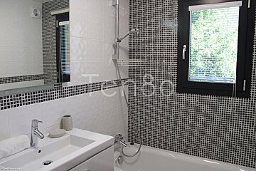 A bathroom with black and white tiles and the word tempo on the wall