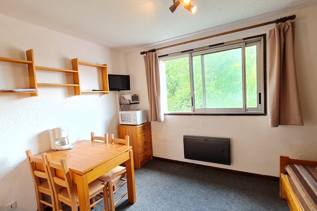 A small room with a table and chairs and a microwave