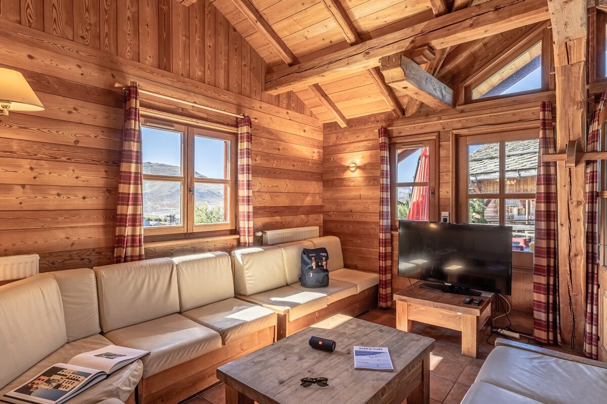 A living room with a couch a table and a television