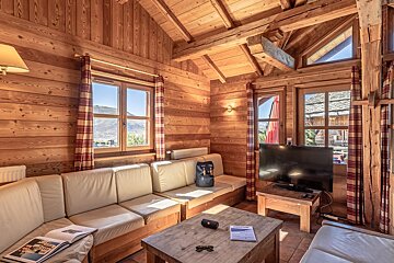 A living room with a couch a table and a television