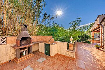 The sun is shining brightly over a barbecue area