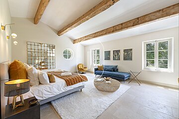 A bedroom with a large bed and a couch