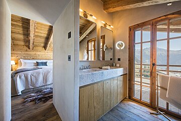 A bathroom with a sink and a mirror next to a window