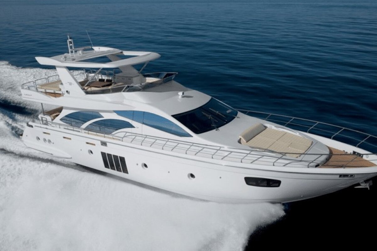 A large white yacht is floating in the ocean