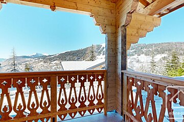 A wooden balcony with the word alpine on the bottom