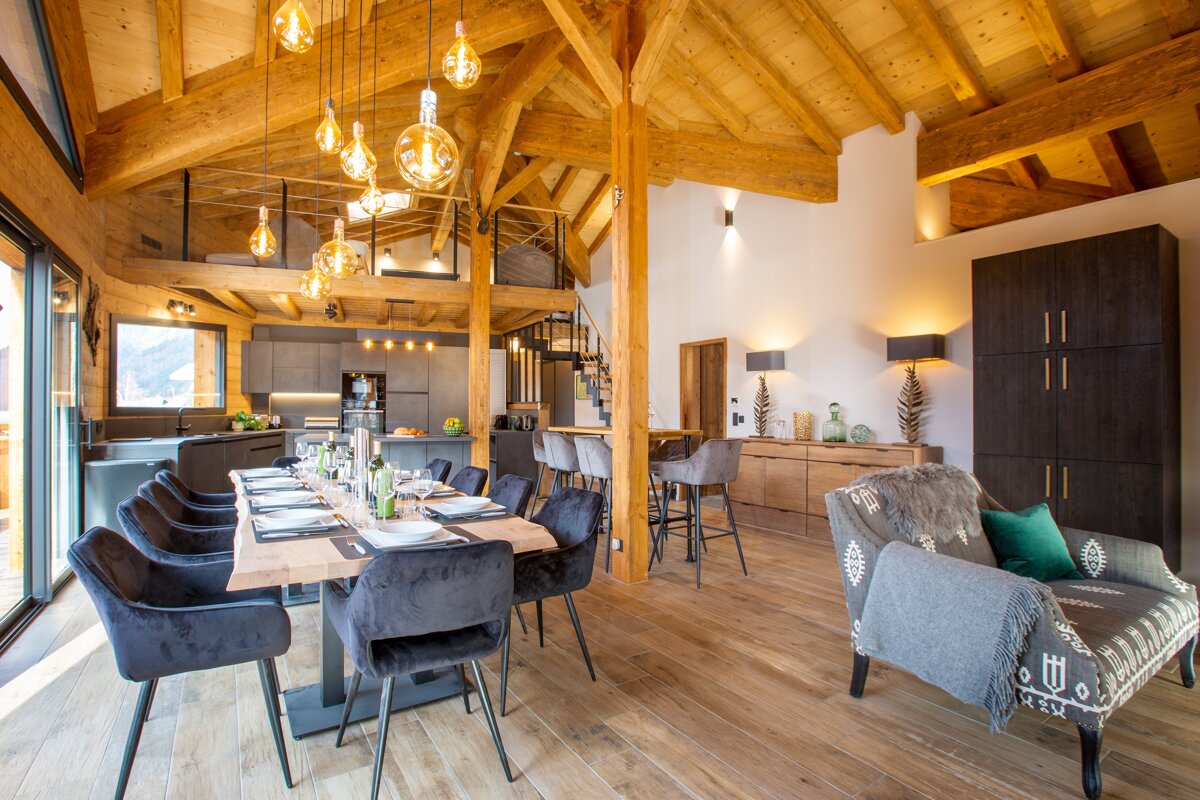 A living room with a dining table and chairs