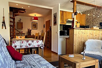A living room with a couch and a table with hearts on it