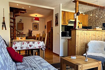 A living room with a couch and a table with hearts on it