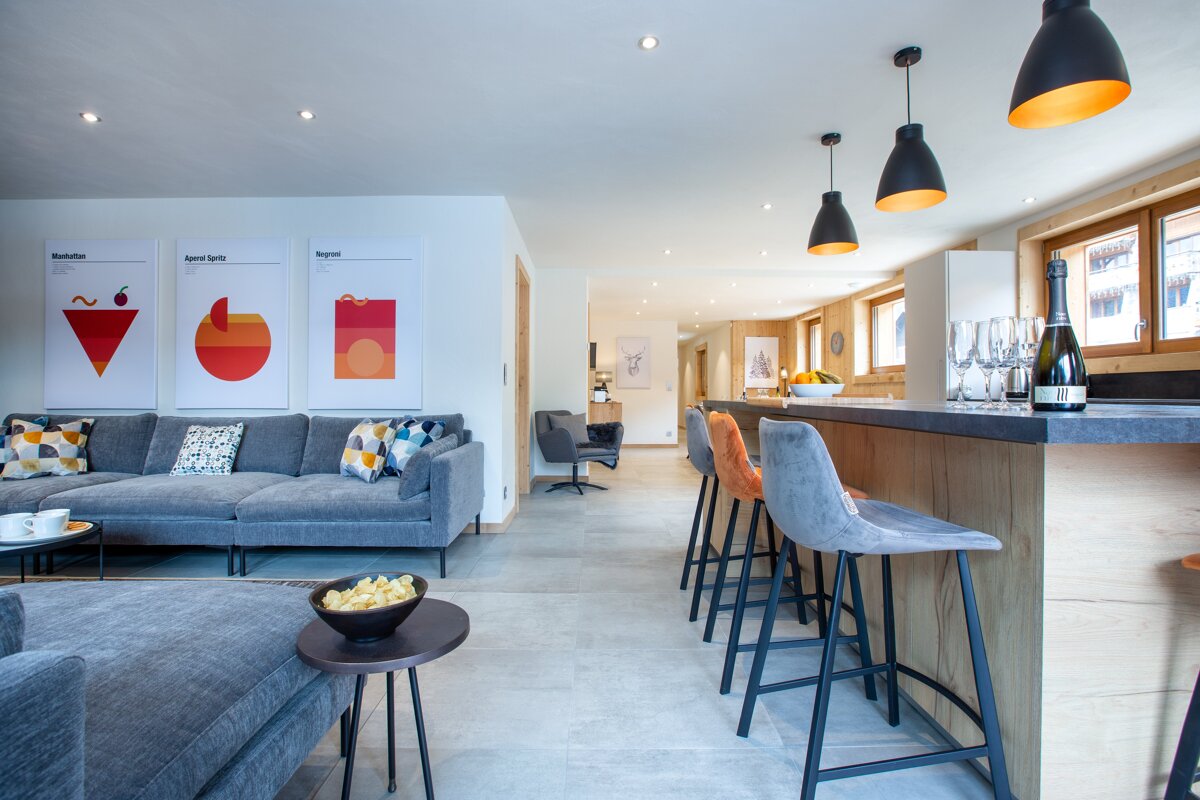 A bottle of champagne sits on a counter in a living room