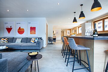 A bottle of champagne sits on a counter in a living room