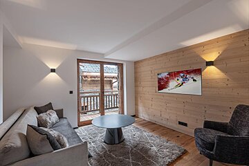 A living room with a painting of a skier on the wall