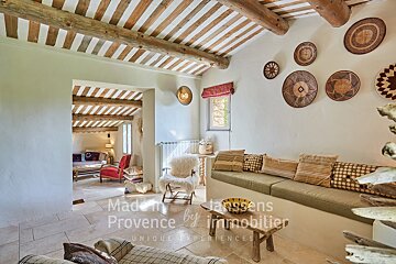 A living room with a couch and chairs and a sign that says made in provence by immobilier