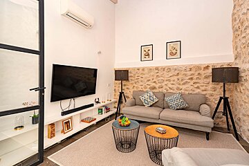 A living room with a couch and a flat screen tv